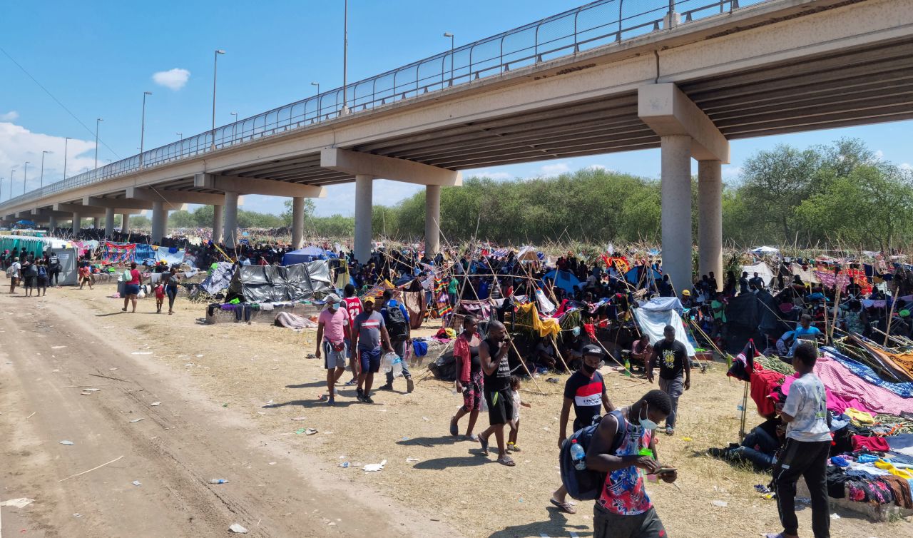 In this photo provided by law enforcement, migrants take shelter under the Del Rio International Bridge that connects Del Rio with Ciudad Acuña.