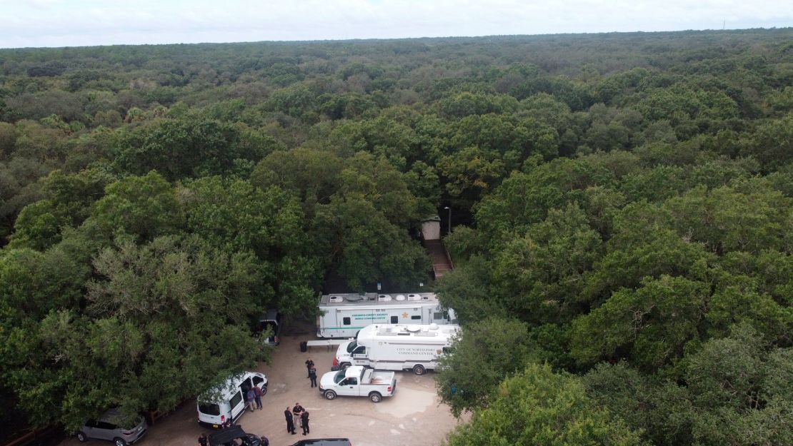 In this photo provided by the North Port Police Department, law enforcement officials conduct a search of the Carlton Reserve in the Sarasota, Florida, area for Brian Laundrie on Saturday.