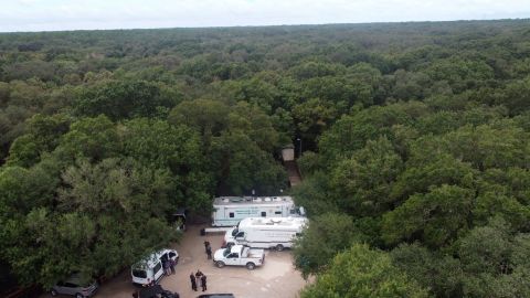 In this photo provided by the North Port Police Department, law enforcement officials conduct a search of the Carlton Reserve in the Sarasota, Florida, area for Brian Laundrie on Saturday.