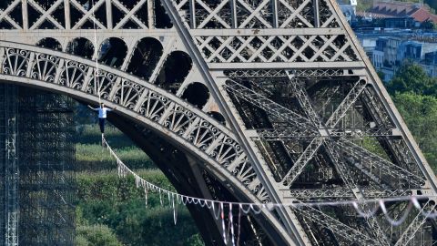 French highliner Nathan Paulin performs on a 70-metre-high slackline spanning 670 metres between the Eiffel Tower and the Theatre National de Chaillot on September 18, 2021.