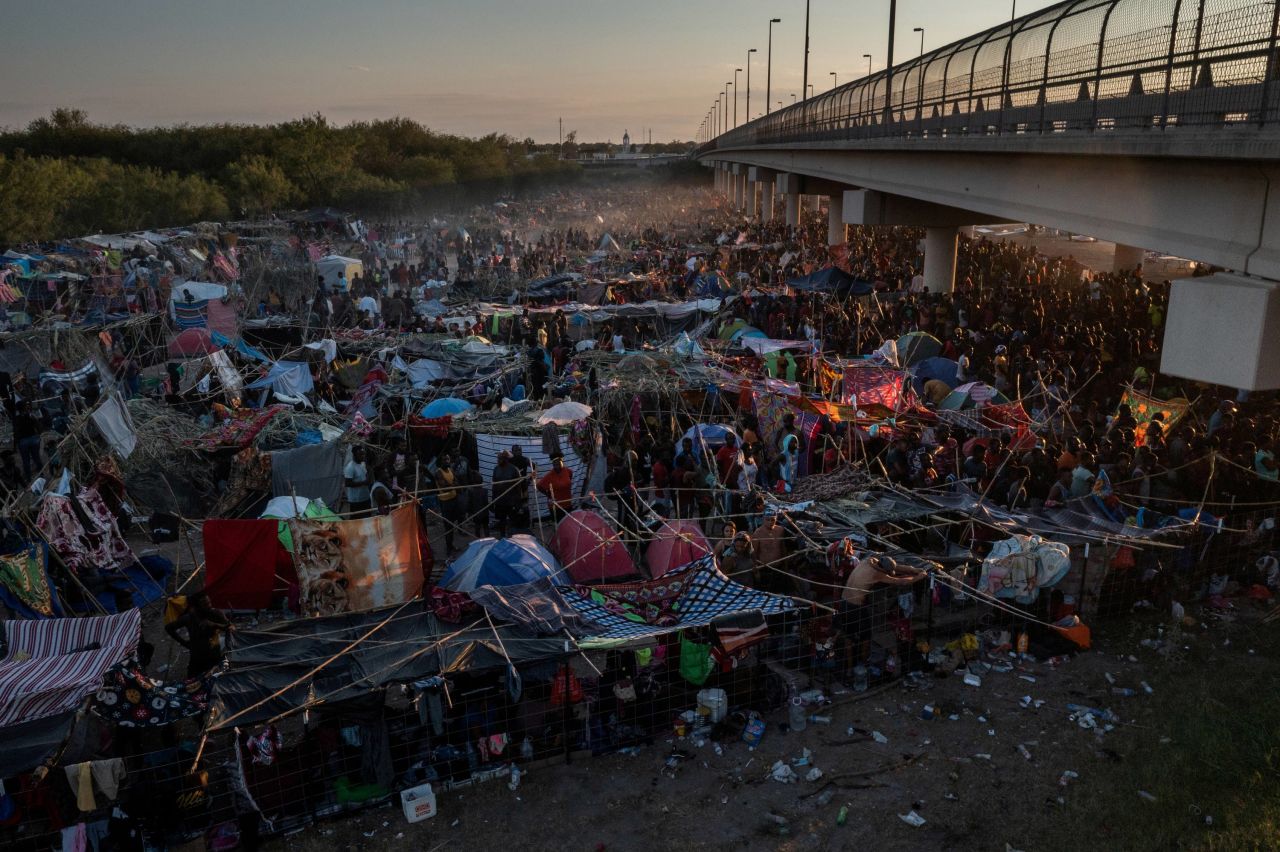 Migrants wait to be processed near the Del Rio International Bridge on Sunday, September 19.