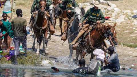 United States Border Patrol agents on horseback try to stop Haitian migrants from entering an encampment on the banks of the Rio Grande near the Acuna Del Rio International Bridge in Del Rio, Texas, on September 19, 2021. 