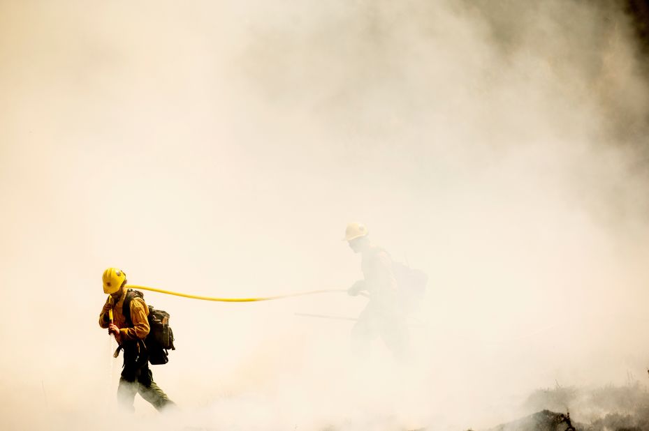 Firefighters battling the Windy Fire extinguish a spot fire in the Sequoia National Forest on September 19.