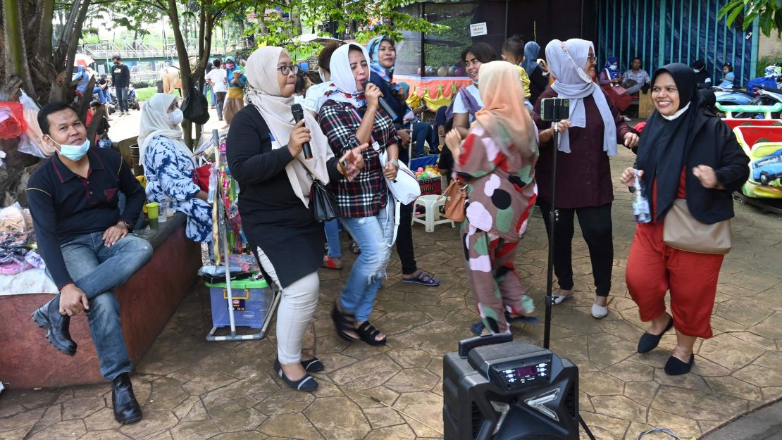 A group of residents gathering for an outdoor karaoke session at a park on the outskirts of Jakarta, Indonesia, on September 19.