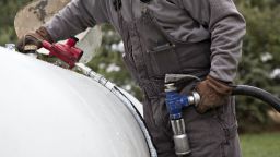 A Michlig Energy worker fills a tank with liquid propane gas during delivery at a home in Manlius, Illinois, on Dec. 14, 2015. 