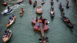 TOPSHOT - "Noah's Violin", a giant floating violin by Venetian sculptor Livio De Marchi, makes its maiden voyage for a concert on the Grand Canal in Venice on September 18, 2021. - Twelve and a half metres of wood, some of it hand-crafted, symbolizing the rebirth of Venice through art, culture and music, said the authors. The floating violin is hosting musicians from the Benedetto Marcello Conservatory playing Vivaldi. (Photo by Marco BERTORELLO / AFP) (Photo by MARCO BERTORELLO/AFP via Getty Images)