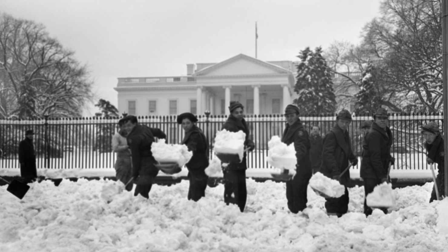 In this March 8, 1941, file photo, Civilian Conservation Corps members from a camp near Washington work to clear White House walks and drives after a snowstorm.