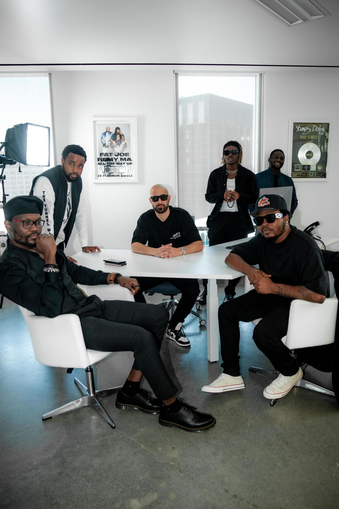 Nigerian recording artists Olamide (front, far right) and Fireboy DML (back, second fom right) with Empire CEO Ghazi Shami (center) and members of the YBNL/Empire team at Empire's headquarters in San Francisco.