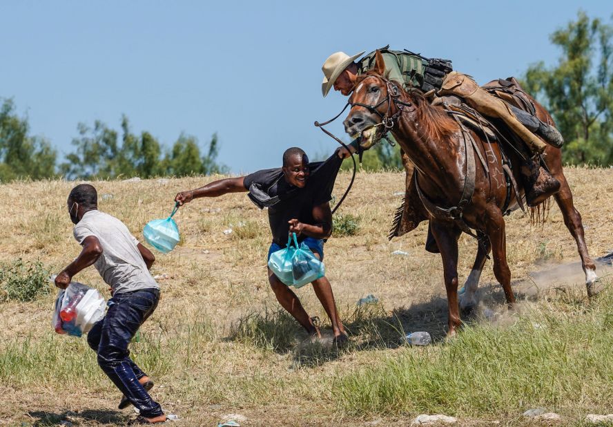 A US Border Patrol agent on horseback tries to stop migrants on the banks of the Rio Grande on September 19.