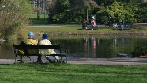 The ultimate niksen: A couple sits on a bench in front of a pond at Wilhelminapark in Utrecht, Netherlands.