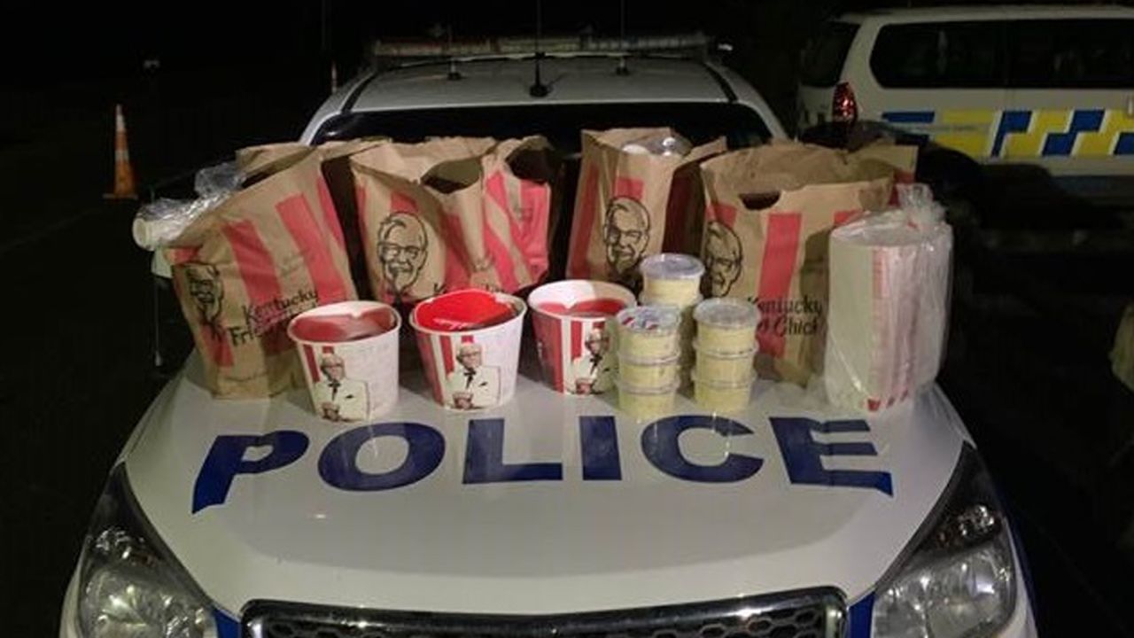 New Zealand Police seize a "car boot full" of Kentucky Fried Chicken after two men attempt to break lockdown rules.