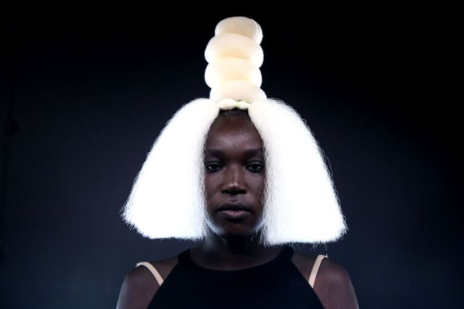 A model wears a peroxide wig backstage at the Labrum show. The label combines British tailoring with West African silhouettes.