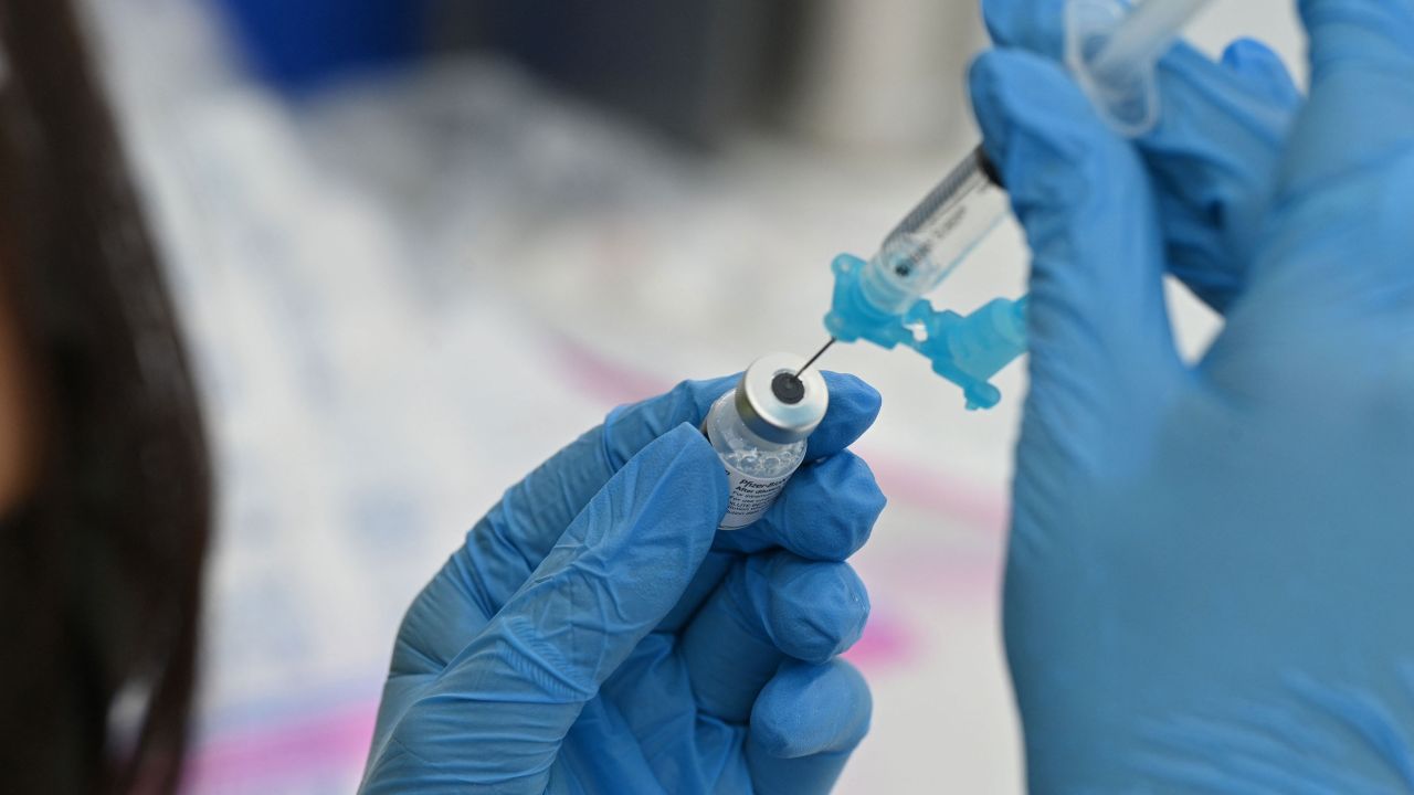 A healthcare worker fills a syringe with Pfizer Covid-19 vaccine at a community vaccination event in a predominately Latino  neighborhood in Los Angeles, California, August 11, 2021. - All teachers in California will have to be vaccinated against Covid-19 or submit to weekly virus tests, Governor Gavin Newsom  announced on August 11, as authorities grapple with exploding infection rates. The number of people testing positive for the disease has surged in recent weeks, with the highly infectious Delta variant blamed for the bulk of new cases. (Photo by Robyn Beck / AFP) (Photo by ROBYN BECK/AFP via Getty Images)