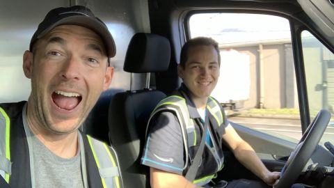 Triton Transportation owner Ryan Schmutzer, left, rides in a delivery van with former driver Branden Fletcher.