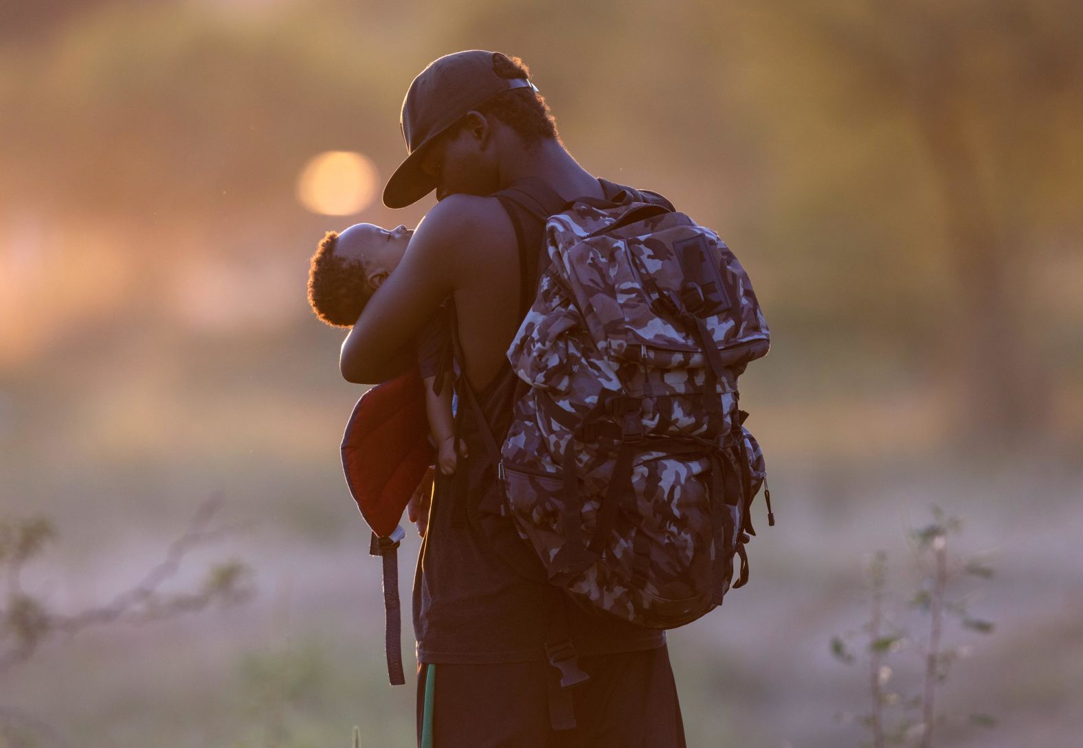 A father cradles his son on the Mexican side of the Rio Grande on September 19.