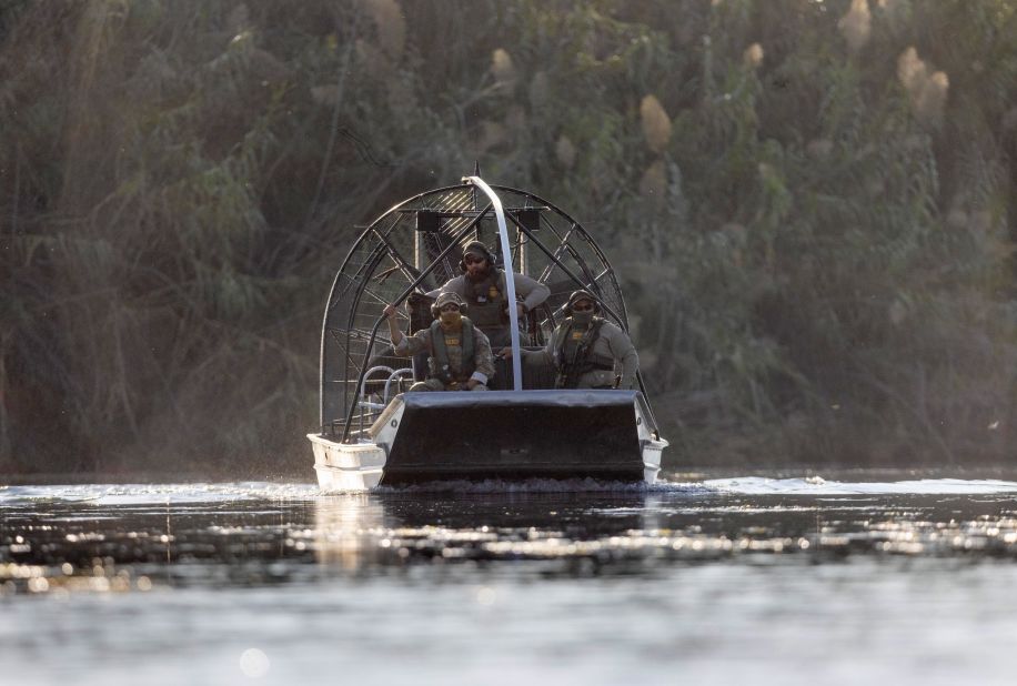 US Border Patrol agents watch migrants cross the Rio Grande on September 20.