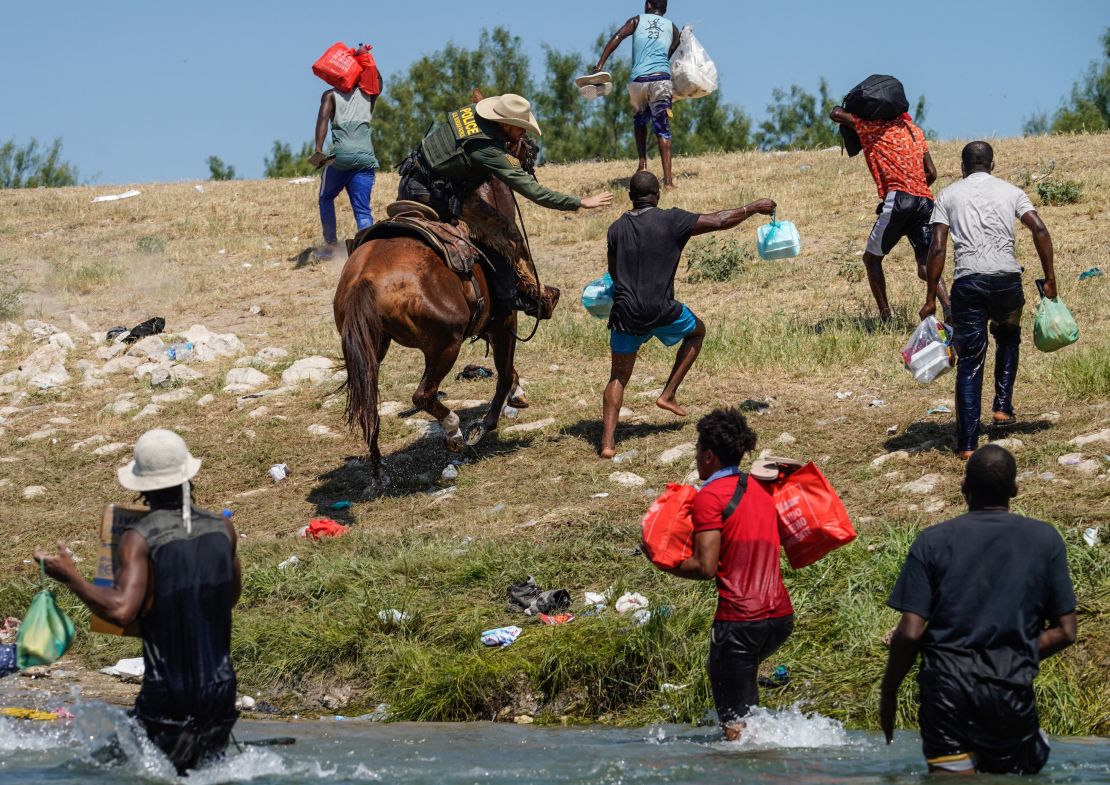 A US Border Patrol agent on horseback tries to stop a Haitian migrant from entering an encampment on the banks of the Rio Grande near the Acuna Del Rio International Bridge in Del Rio, Texas, on September 19, 2021. 