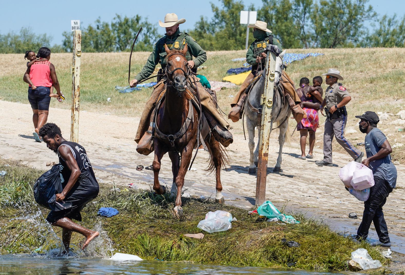 US Border Patrol agents confront migrants in Del Rio on September 19.