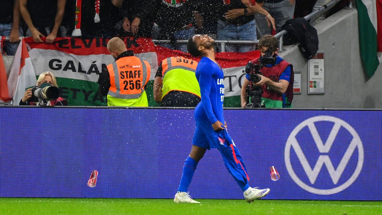 Hungary's fans react throwing cups of beer at England forward Raheem Sterling.