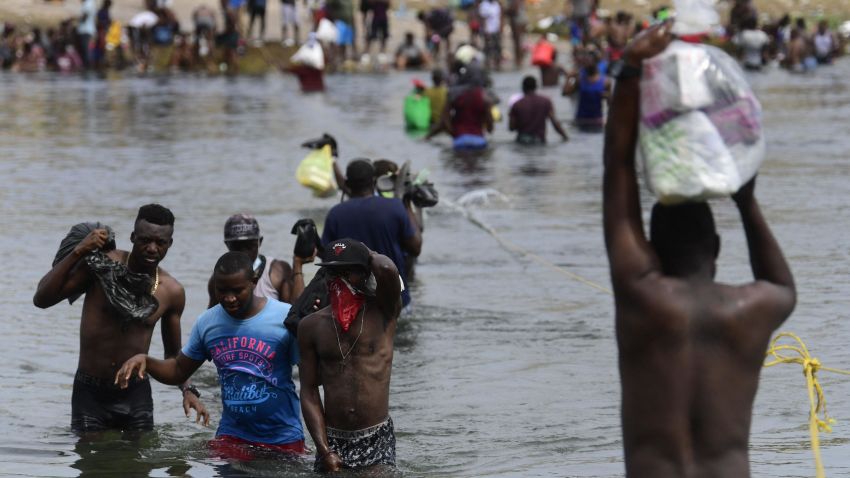 Haitian migrants cross the Rio Grande river to get food and water in Mexico, as seen from Ciudad Acuna, Coahuila state, Mexico on September 21, 2021. - Mexico has told the United States that it wants a regional agreement to tackle the tide of migrants arriving at the two countries' borders, Foreign Minister Marcelo Ebrard said Tuesday. (Photo by PEDRO PARDO / AFP) (Photo by PEDRO PARDO/AFP via Getty Images)