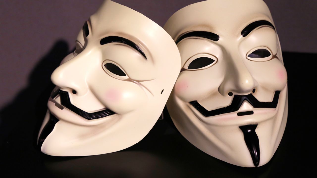 In this February 12, 2018, file photo, Guy Fawkes masks, often associated with the hacker group Anonymous, are displayed in a section about hacking at the Spyscape espionage museum in New York.
