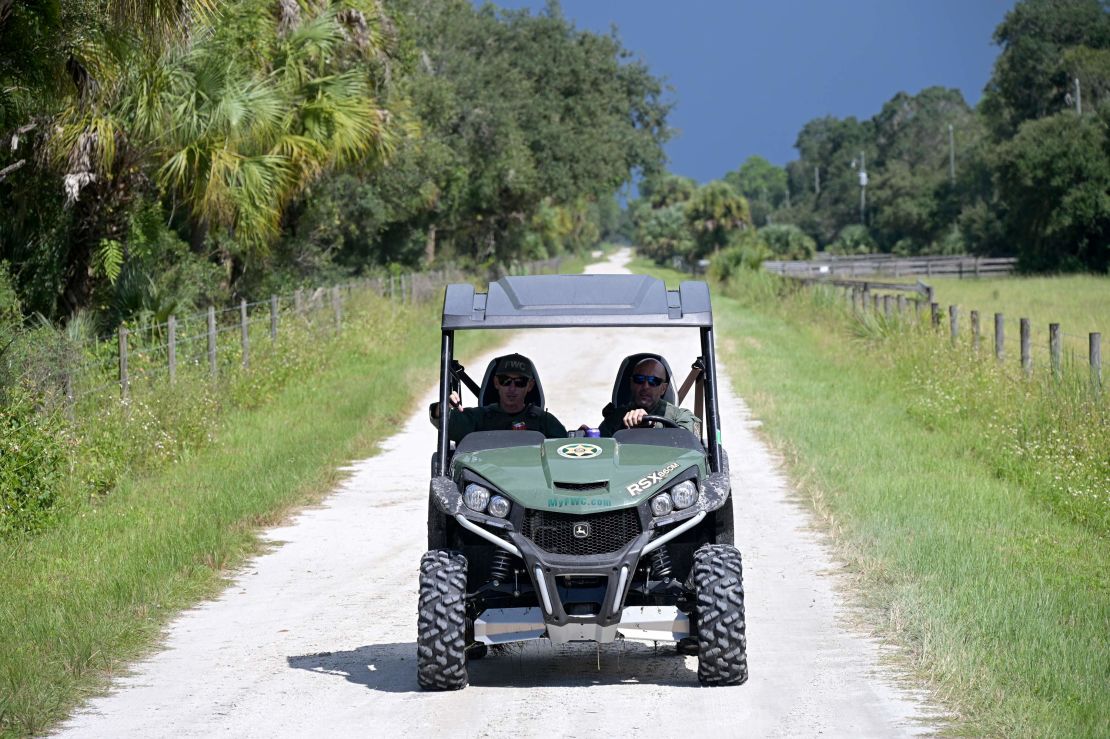 Florida Fish and Wildlife Commission officers ride up a private road near the entrance of the Carlton Reserve during a search for Brian Laundrie  on September 21.