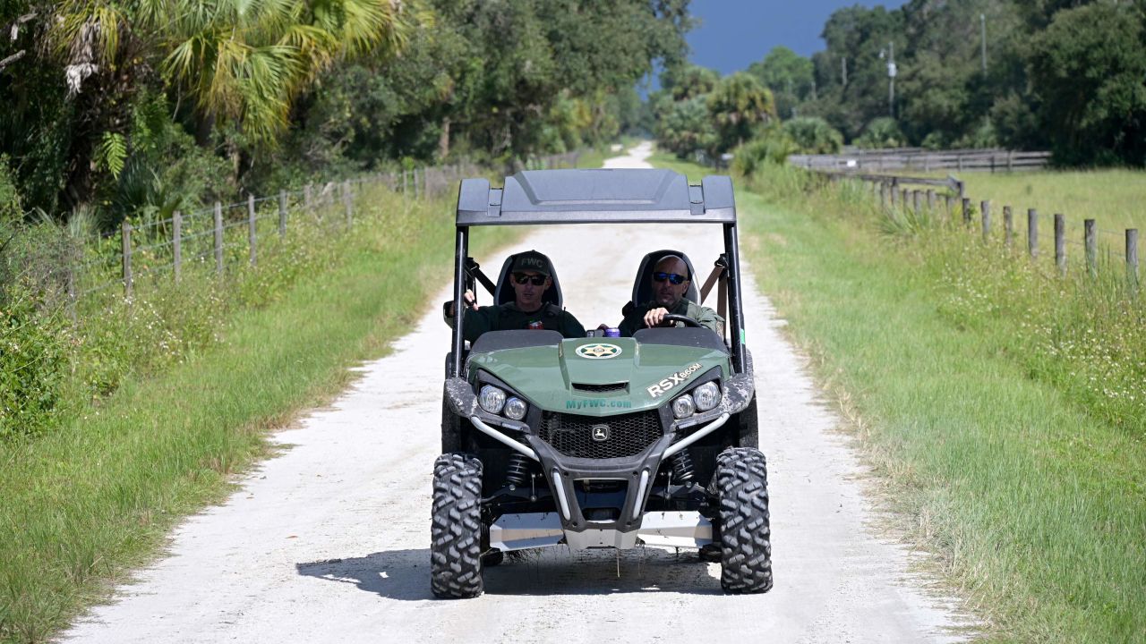 Florida Fish and Wildlife Commission officers ride up a private road near the entrance of the Carlton Reserve during a search for Brian Laundrie.