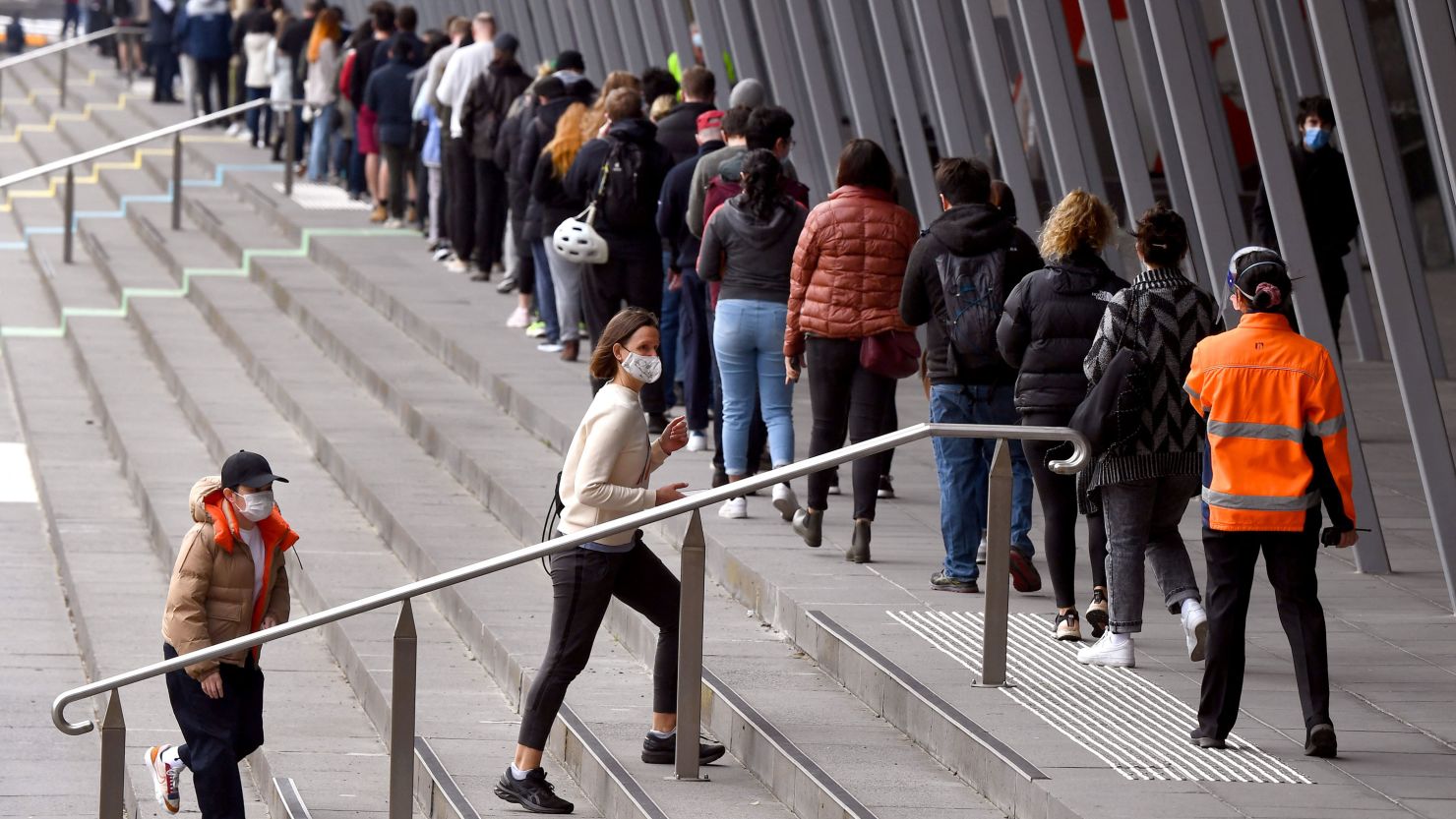 People form long queues outside a vaccination center in Melbourne on August 27, 2021. 