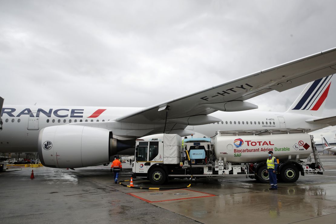 Workers refuel an Airbus A350 with sustainable aviation fuel at Roissy airport, north of Paris, on May 18, 2021.