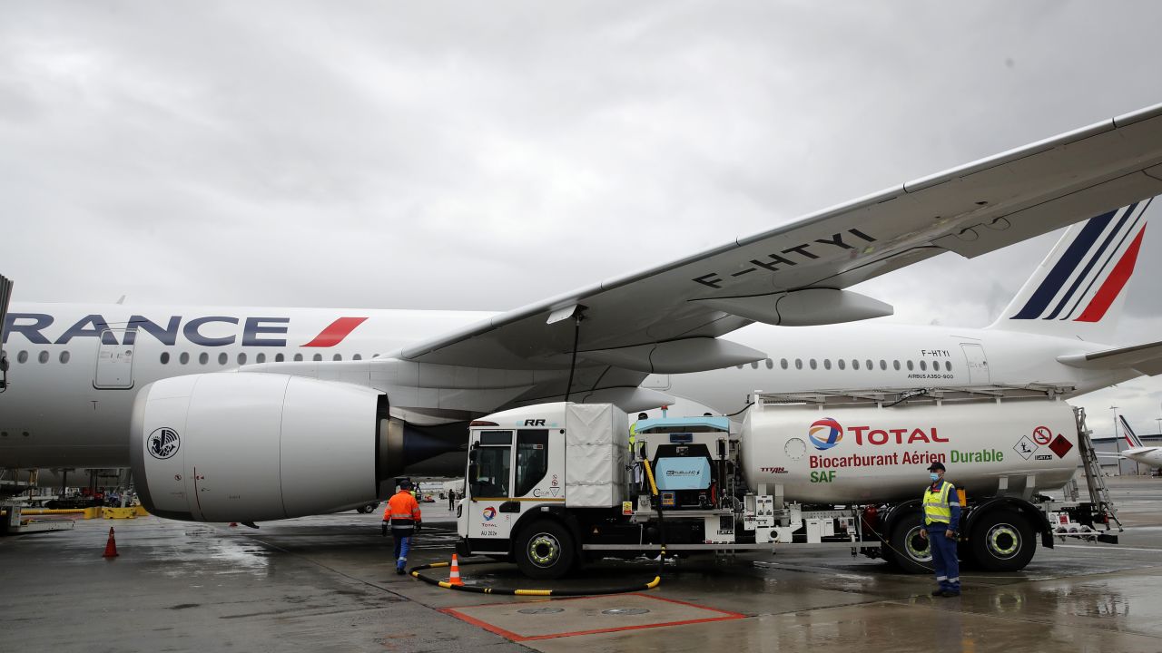 Workers refuel an Airbus A350 with sustainable aviation fuel at Roissy airport, north of Paris, on May 18, 2021.