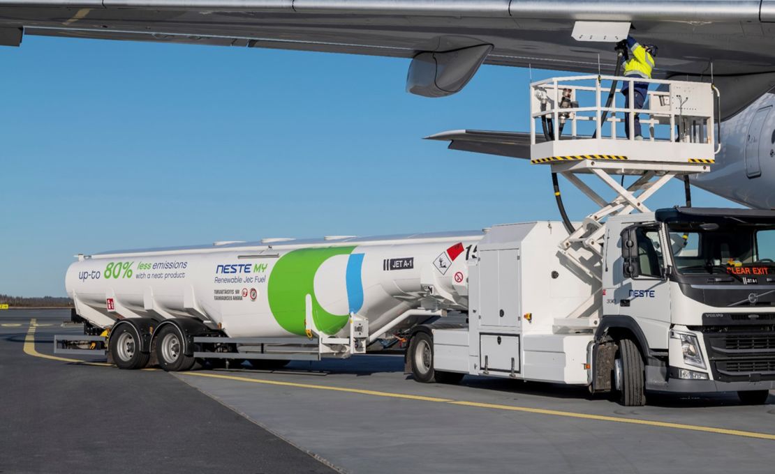 A tanker truck fuels a plane with SAF produced by Finland's Neste at Helsinki Airport.