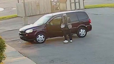 Video surveillance footage shows a man placing a box outside of an AT&T store in Sault Ste. Marie, Michigan, on September 15, 2021.