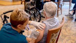 A healthcare worker administers a third dose of the Pfizer-BioNTech Covid-19 vaccine at a senior living facility in Worcester, Pennsylvania, U.S., on Wednesday, Aug. 25, 2021. Pfizer Inc. and BioNTech SE are seeking full U.S. approval for a Covid-19 booster shot for people 16 and older, asking regulators to sign off on a third dose to quell a rise in infections among vaccinated people. Photographer: Hannah Beier/Bloomberg via Getty Images