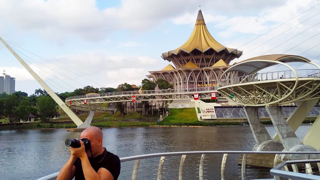 <strong>Giving it a go:</strong> The couple also advise not to overthink traveling. "The worst enemy of oneself is probably your own fears," says Nieto Carvajal. "Don't be so scared of trying." Here's Piñas Rodríguez photographing the sea promenade at Kuching, Malaysia, in 2019.