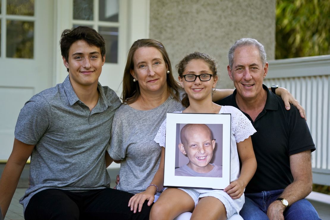 Nancy Goodman (second from left), with Ben (left), Sarah, husband Michael and a photo of Jacob. 