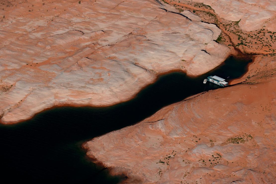 A house boat sits docked in a section of Lake Powell, as severe drought grips parts of the Western United States