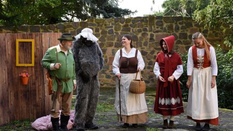 Characters perform "Little Red Riding Hood" at the monestary garden.