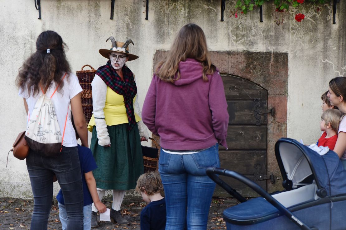 A storyteller dressed as a goat leads a tour of the Brothers Grimm House.