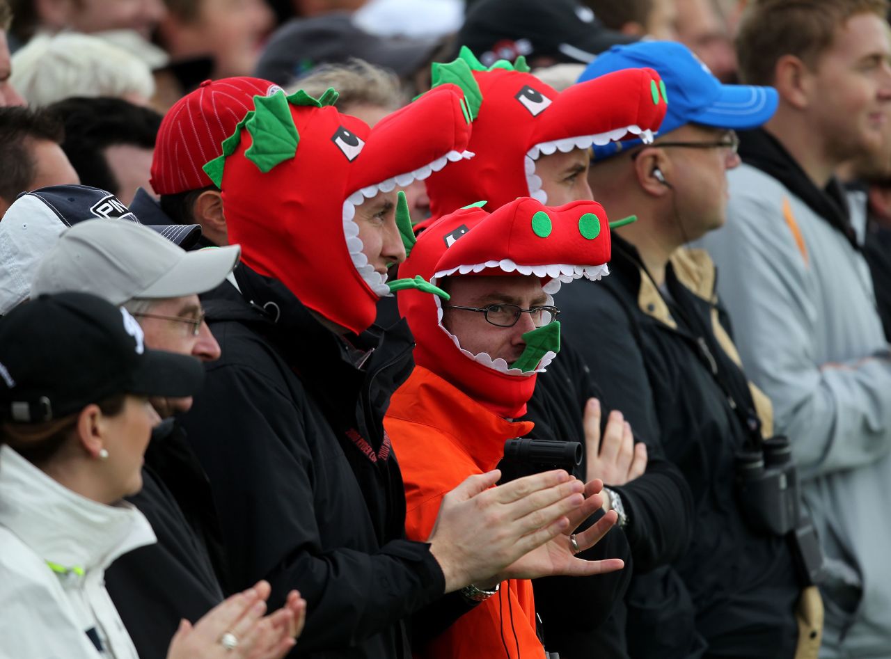 Welsh fans in dragon outfits watch the play during the 38th Ryder Cup.