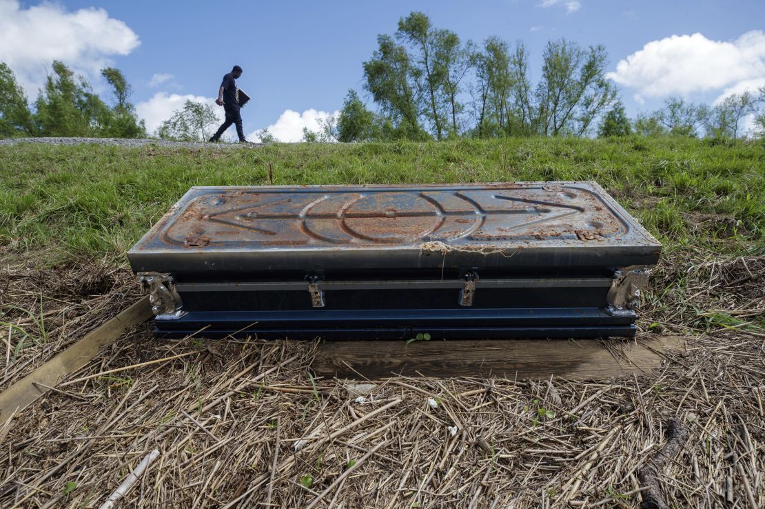 An overturned casket lays against Ironton's Mississippi River Levee on September 19.
