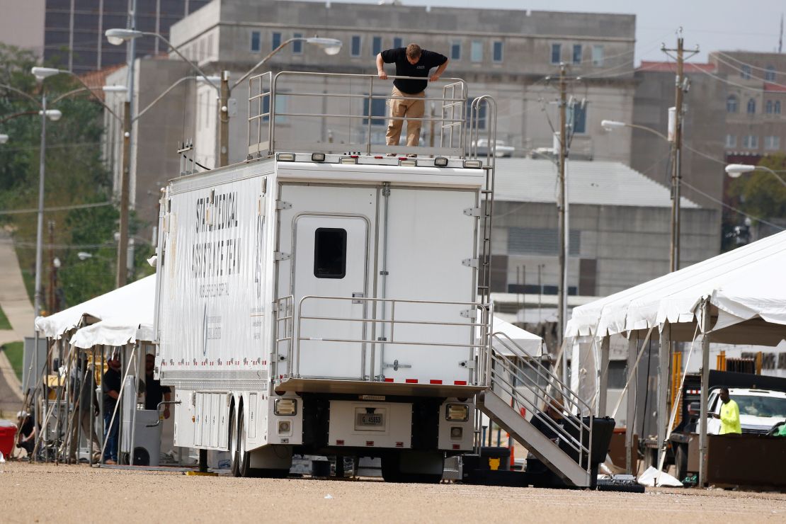 A worker secures a railing on a state-run mobile field hospital at the Mississippi State Fair Grounds on March 19, 2020, in Jackson.