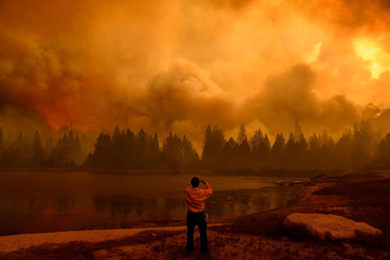A public information officer takes pictures during the Windy Fire in Sequoia National Forest, near Johnsondale, California, on Wednesday, September 22.