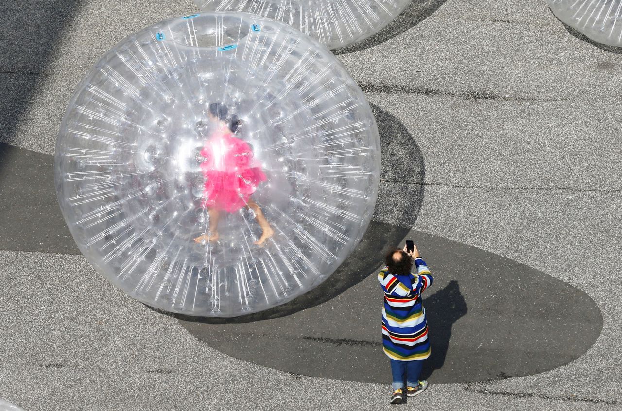 An artist is seen in a giant transparent balloon during a performance of Monster Chetwynd's "Tears" during Art Basel at Messeplatz square in Basel, Switzerland, on Tuesday, September 21. The sculptural installation and performance "was inspired by Salvador Dalí's jewel in form of a crying eye," <a href="https://artbasel.com/events/detail/23302/Monster-Chetwynd-Messeplatz-Performance" target="_blank" target="_blank">according to Art Basel.</a>