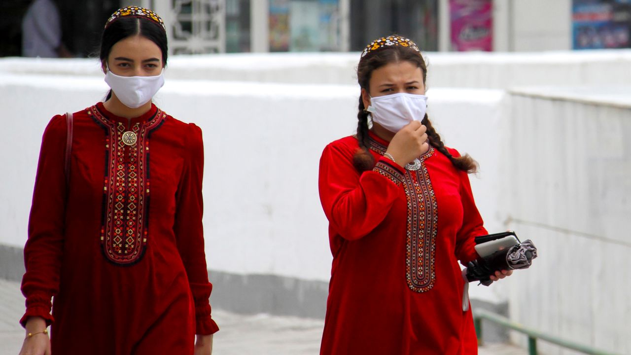 Turkmen women wearing face masks walk in Ashgabat on July 13, 2020. 