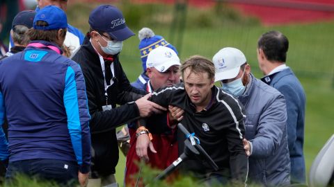 Felton is helped off the course on the 18th hole at Whistling Straits.