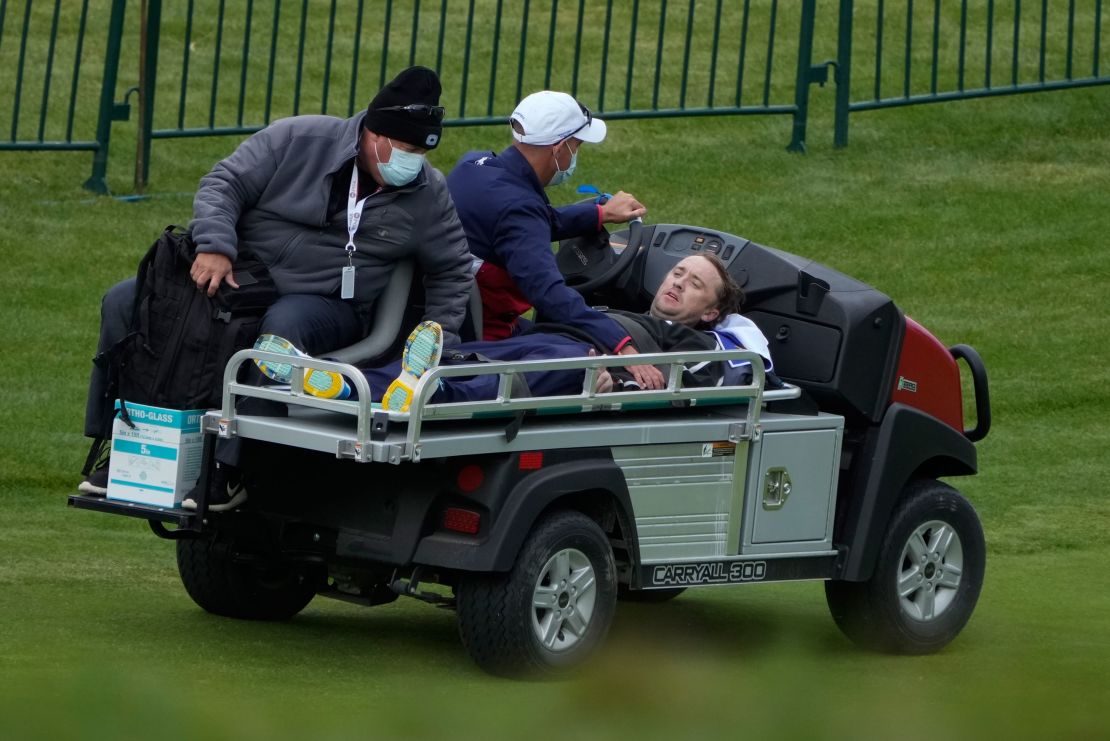 Felton is carted off the course.