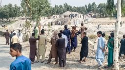 Taliban members and people gather at the site of a bomb explosion which targeted a pickup truck carrying Taliban fighters in Jalalabad on September 19, 2021, a day after at least two people were killed in a series of blasts in the area.