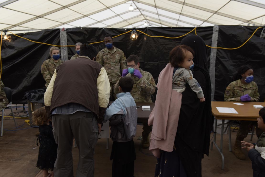 US Air Force Airmen evaluate evacuees waiting to be vaccinated with the measles, mumps, and rubella and varicella vaccines at Ramstein Air Base.