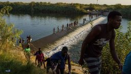 Haitian migrants cross the Rio Grande to get food and supplies near the Del Rio-Acuña, Port of Entry in Ciudad Acuña, Coahuila state, Mexico on September 18, 2021. 