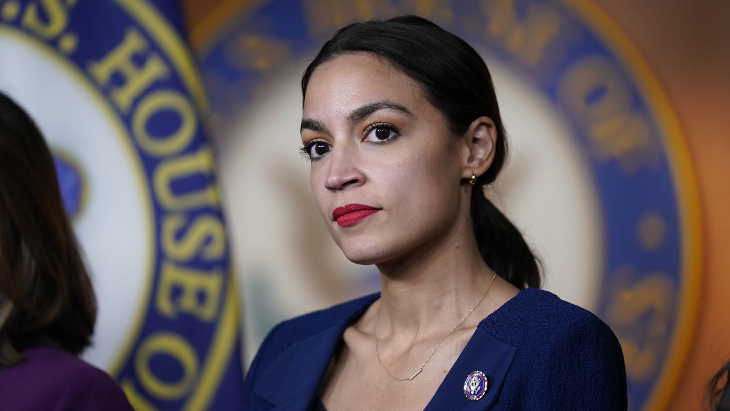 In this June 16, 2021, file photo, Rep. Alexandria Ocasio-Cortez, D-N.Y., listens as House Speaker Nancy Pelosi, D-Calif., speaks during a news conference at the Capitol in Washington. 